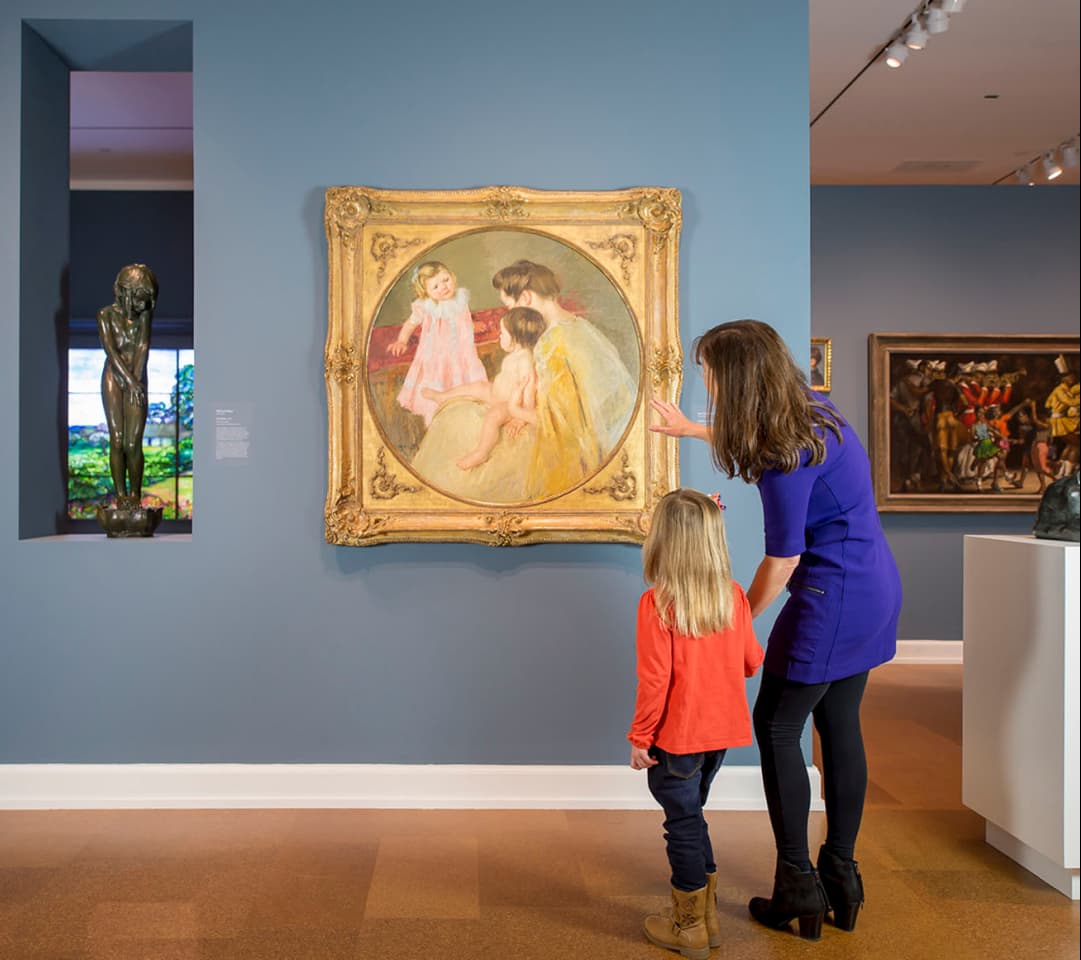 A woman and a young girl looking at the painting “Mother and Two Children” by Mary Stevenson Cassatt, located in The Westmoreland’s 20th Century Gallery.