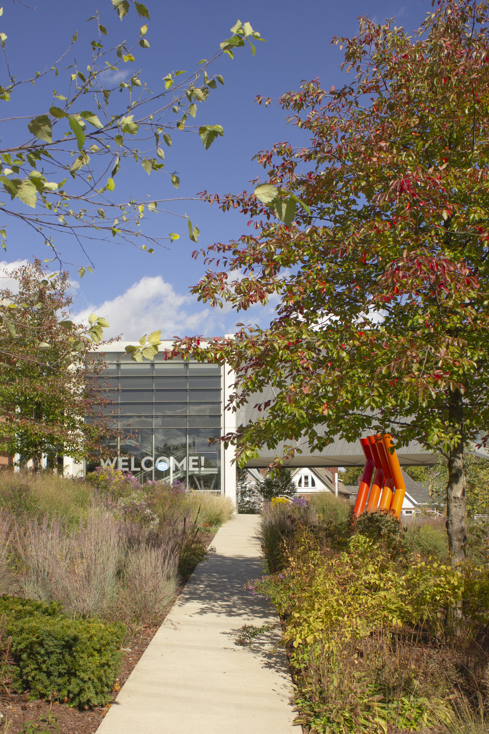 Image of walkway in garden area on south side of Museum with sculpture in view at right